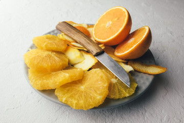 Orange pieces on grey plate closeup. Healthy diet vitamin concept. Food photography