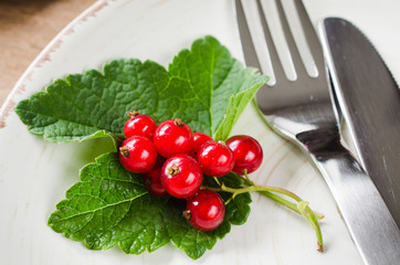 Fresh ripe organic red currant in plate.