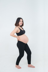 Fototapeta na wymiar Portrait of asian pregnant woman on white background,thailand people,Back pain because the weight up quickly.