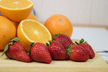 Fototapeta na wymiar Strawberries and oranges in macro view