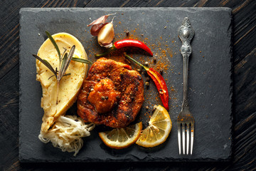 Beef steak with mashed potatoes, spices and sauce.