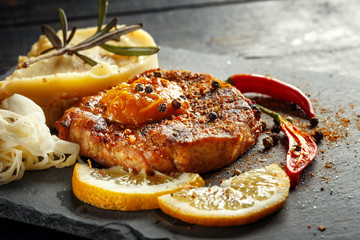 Beef steak with mashed potatoes, spices and sauce.