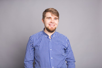 Fototapeta premium Portrait of a handsome young man against blue background