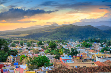 beautiful cozy city surrounded by mountains at sunset