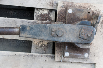 Old hand tool for bending pipe is fixed on a tree