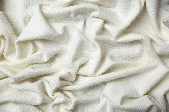 Cotton blanket with an interesting texture and crumpled irregularly in a rather artistic way.

