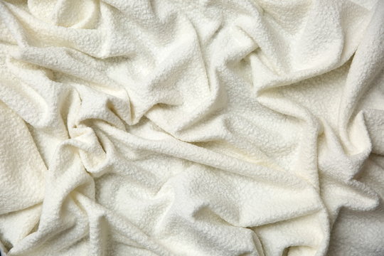 Cotton blanket with an interesting texture and crumpled irregularly in a rather artistic way.


