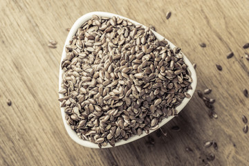 Flax seeds linseed in bowl on wooden table