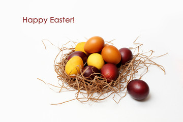 red and yellow Easter eggs in basket on white background