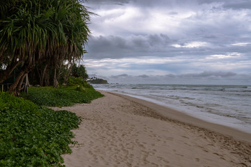Tropical beach in Sri lanka. Cloudy sky