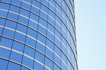low angle view of modern curved blue glass building