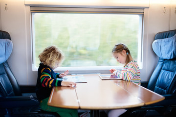 Kids travel by train. Railway trip with child. © famveldman