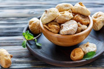 Wooden bowl with dried figs.