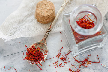 Bottle and spoon with saffron threads.