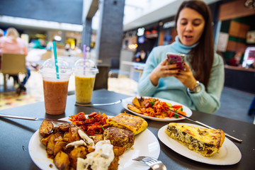 lunchtime in cafe. blurred woman on background into her phone. lifestyle.
