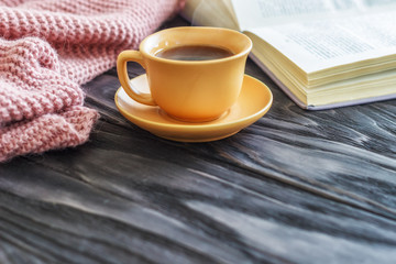 open book cup with coffee on a wooden background with copy space, top view