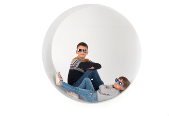 Boy and girl in sunglasses posing on camera. On isolated white background in scenery.