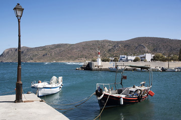 Milatos, Crete, Greece. 2017. The small fishing harbour with mountains joining the Sea of Crete.