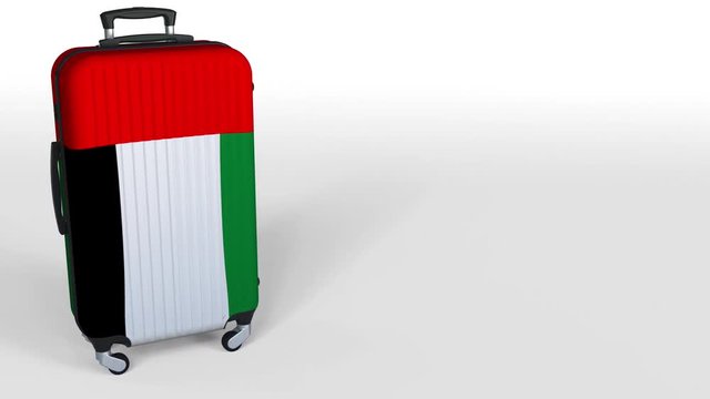 Traveler's suitcase featuring flag of the United Arab Emirates. UAE tourism conceptual animation, blank space for caption