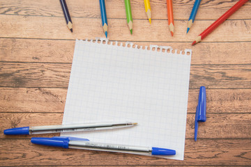 School supplies. Color pencils,note book, blue pens, sciccors, markers, glue, pencil sharpener, clips