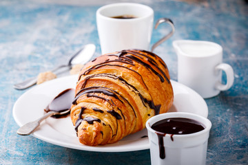   Breakfast Continental  with Fresh  Croissants on a blue Background Coffee  and milk Delicious Baking with  with Chocolate Topping