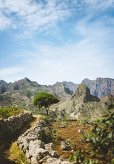 Fototapeta na wymiar Hiking trail leading through arid rocky terrain towards Coculli village on Santo Antao Cape Verde