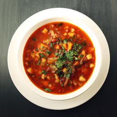 Tomato soup with red beans, potato and carrot. Vegan diet. European cuisine. Vegetarian dish. Main course. Organic meal. Toned photo. Top view.