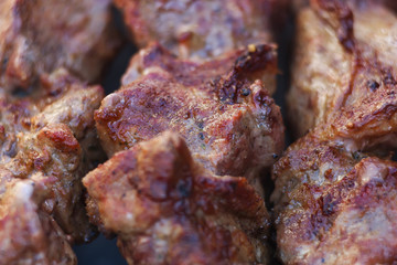 Lovely fresh pieces of smoked meat shish kebab fried on charcoal grill. Roast the meat close up