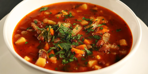 Tomato soup with red beans, potato and carrot. Vegan diet. European cuisine. Vegetarian dish. Main course. Organic meal. Wide photo.