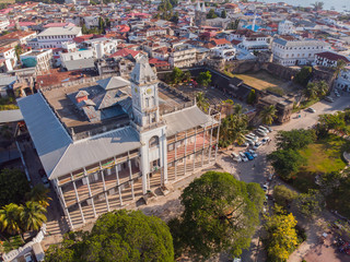 AERIAL view of the Stone Town, old part of Zanzibar City. Flight above main city of Zanzibar, Tanzania, Africa, Indian Ocean - obrazy, fototapety, plakaty