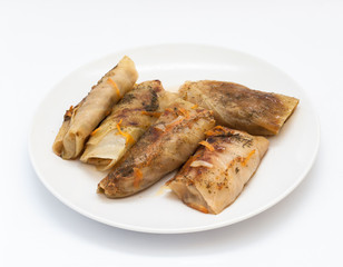 Tasty stuffed cabbage leaf laying on plate on isolated white background