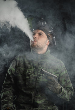 a photo of a guy in a gas mask in the smoke. smokes Viper