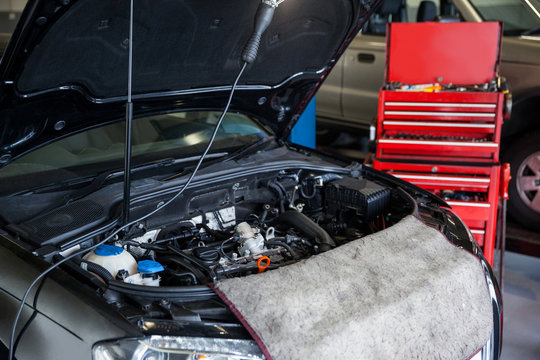 Cars with open hood for servicing