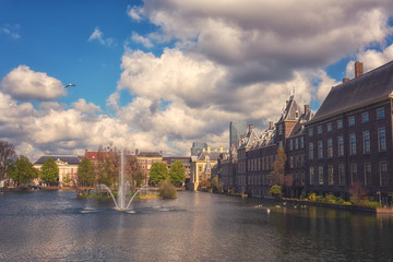 Naklejka premium Binnenhof castle (Dutch Parliament) background with the Hofvijver lake, a complex of buildings in the Gothic style in the city centre of Hague (Den Haag), Netherlands