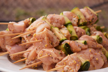 Raw Marinated Chicken Meat Skewers. Barbeque Summer Picnic Food. Grilled Meat over Wooden Background with Spices