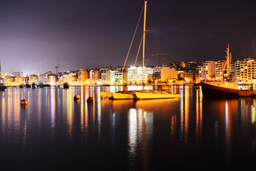 Fototapeta na wymiar The view on Sliema and sail yacht in sunset, Sliema, Malta