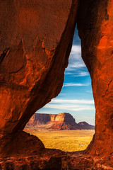 The Eagle Mesa seen through the Teardrop Arch in Monument Valley Navajo Tribal Park at sunset with...