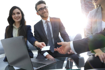 Close-up of two businesspeople exchanging visiting card