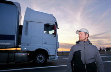  A young man with a moving truck in the background
