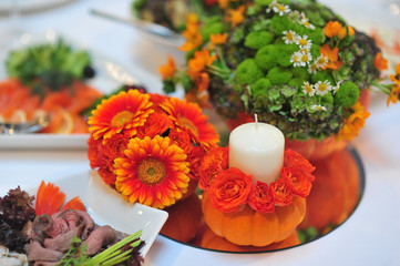 Autumn still life with flowers and pumpkin and candles. Decoration of wedding reception