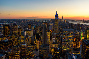New York City skyline at night - skyscrapers of midtown Manhattan with Empire State Building at Amazing Sunset - USA