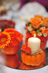 Autumn still life with flowers and pumpkin and candles. Decoration of wedding reception