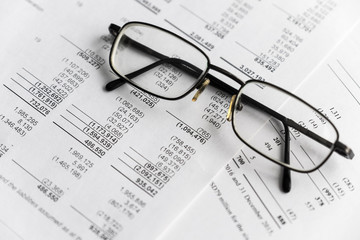 Business composition. Financial analysis - income statement, business plan with glass