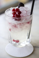 Cocktail with blueberries and ice cubes