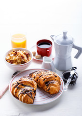 Croissant with Chocolate Espresso with milk and a glass of orange juice Tradition Dry Dry with goji berries Morning Baking sweet Dessert on the White Background