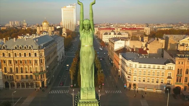 RIGA - 15 SEPTEMBER, 2017: Panoramic View of the Statue of Liberty - Milda in Riga, Latvia, Holding 3 stars Above Her Head, Aerial View of the Riga City during Sunset in Autumn