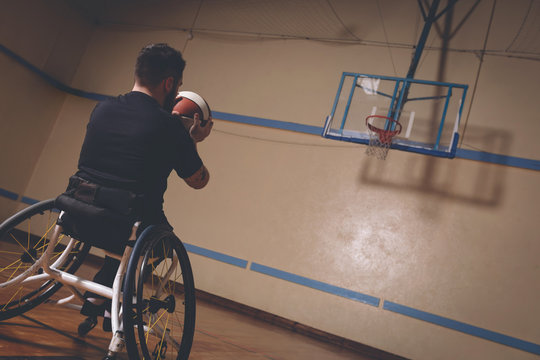 Disabled man practicing basketball in the court 