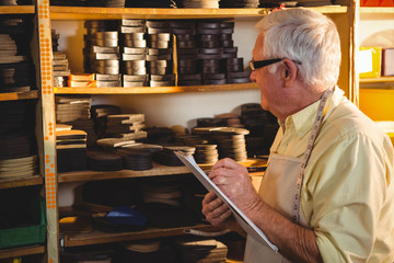 Shoemaker writing on clipboard
