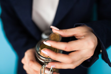 Woman holding a 2 Euro coin