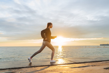 active young girl runner trains before a long race, at sunset, leads a healthy lifestyle © mnelen.com